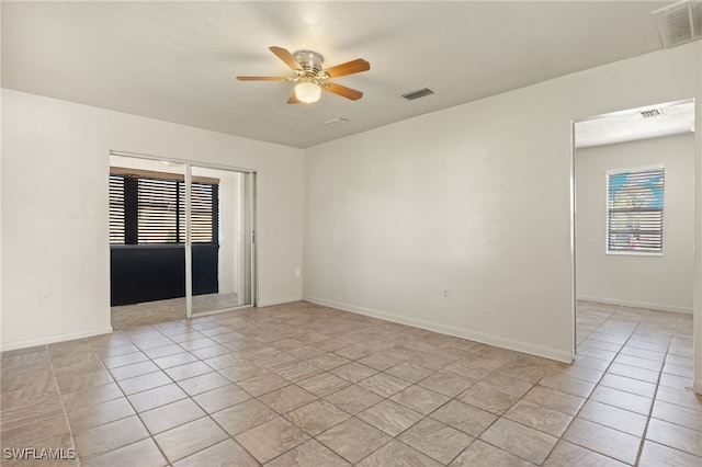 unfurnished room with light tile patterned floors and ceiling fan