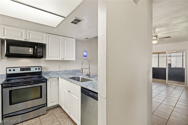 kitchen featuring appliances with stainless steel finishes, sink, light stone counters, white cabinetry, and ceiling fan