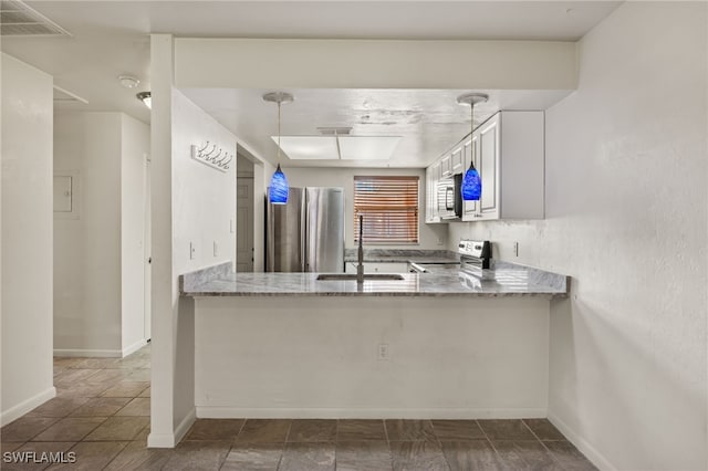 kitchen with stove, stainless steel fridge, sink, tile patterned flooring, and white cabinetry