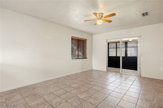 unfurnished room featuring light tile patterned floors and ceiling fan