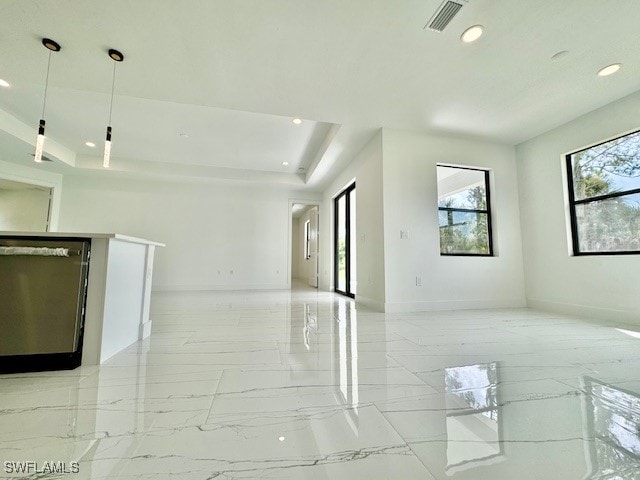 unfurnished living room featuring a tray ceiling