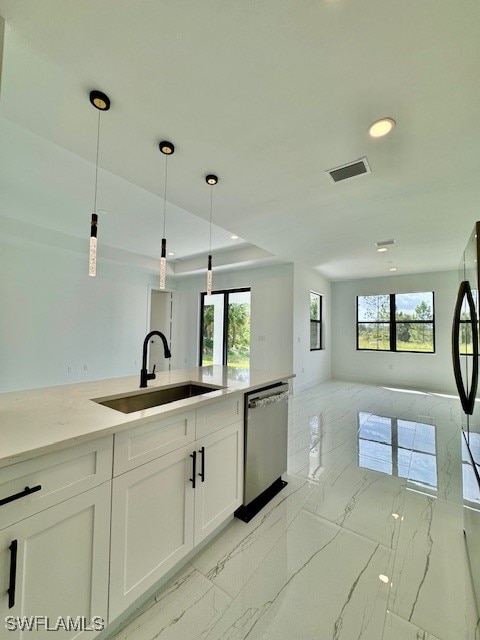 kitchen with appliances with stainless steel finishes, sink, a healthy amount of sunlight, and hanging light fixtures