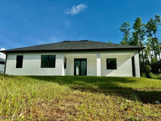 rear view of house with a yard