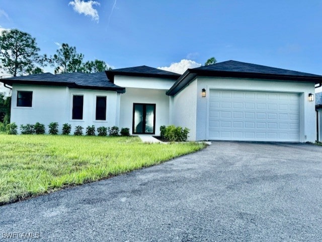 view of front of home with a garage and a front yard