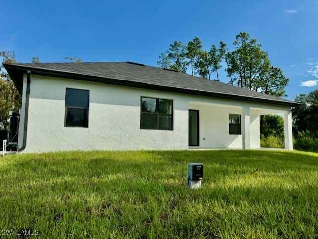 back of house with a yard