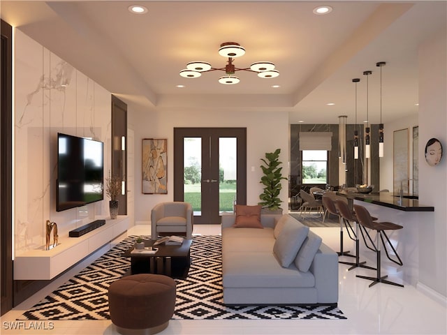 living room featuring french doors, sink, and a tray ceiling