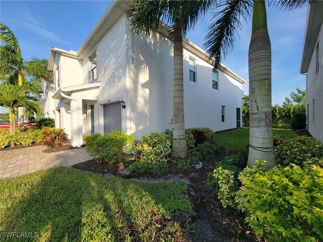 view of side of property with a lawn