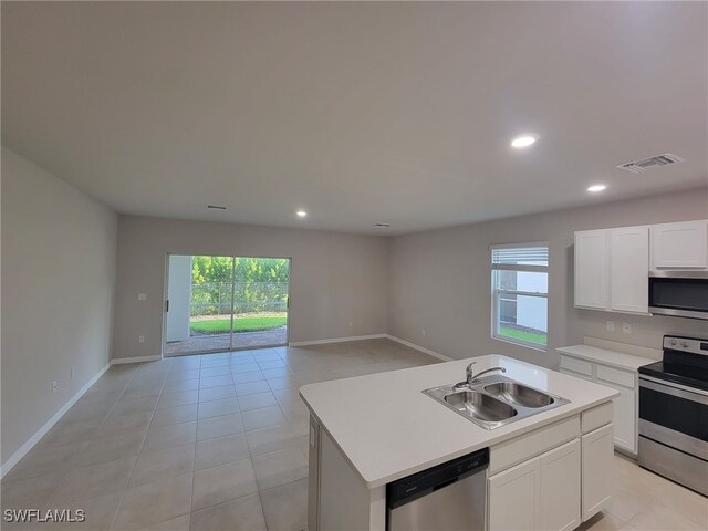 kitchen featuring sink, a kitchen island with sink, stainless steel appliances, and light tile patterned floors