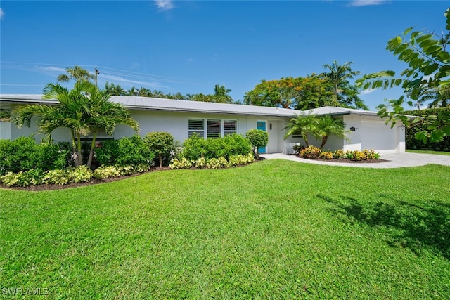 ranch-style home with a garage and a front yard