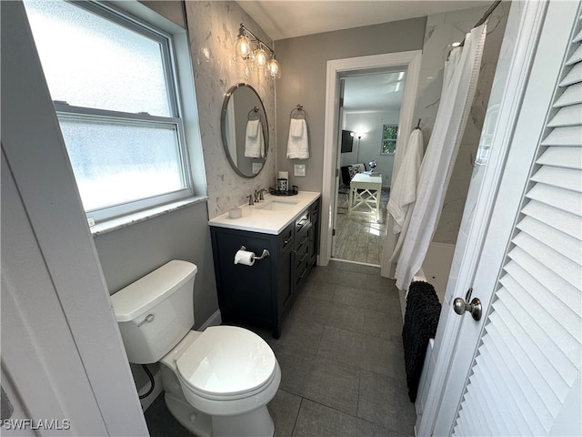 bathroom with vanity, plenty of natural light, and toilet