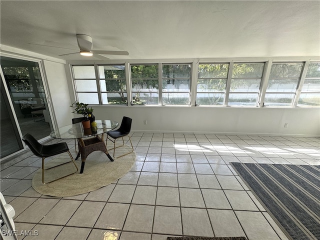 sunroom / solarium featuring ceiling fan