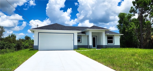 view of front of home with a garage and a front lawn