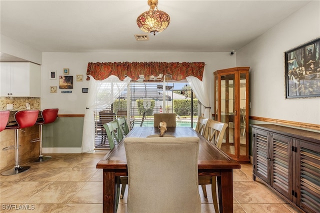 dining room with baseboards and visible vents