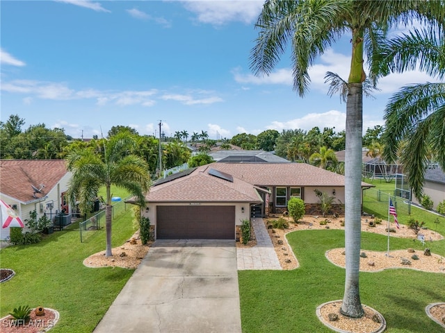 ranch-style home with fence, a front yard, stucco siding, driveway, and an attached garage