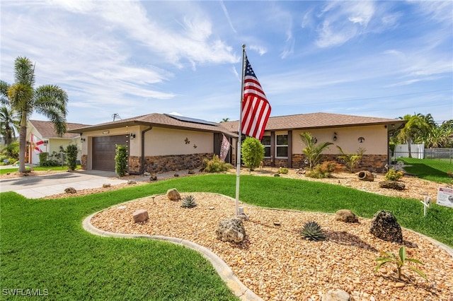 view of front of home featuring stucco siding, stone siding, roof mounted solar panels, and concrete driveway