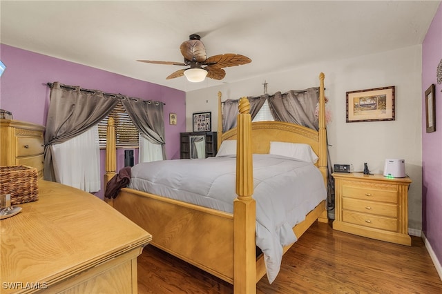 bedroom featuring ceiling fan, baseboards, and wood finished floors