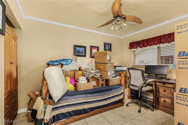 office area with a ceiling fan, crown molding, and tile patterned flooring