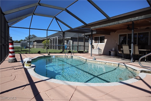 view of swimming pool featuring a ceiling fan, a fenced in pool, a patio area, and fence