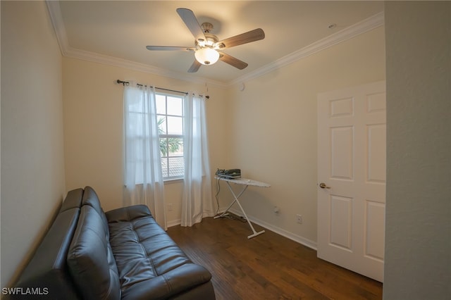 living area with dark hardwood / wood-style flooring, crown molding, and ceiling fan