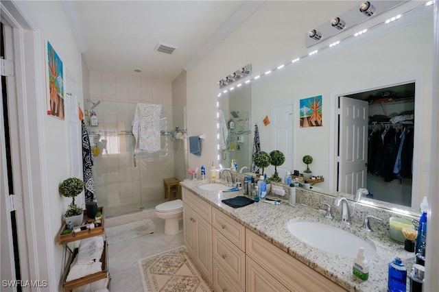 full bathroom featuring visible vents, a sink, a shower stall, and double vanity