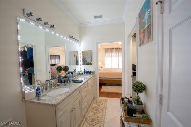 bathroom with double vanity, hardwood / wood-style flooring, and crown molding