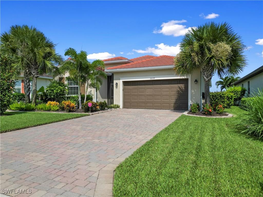 view of front of home with a garage and a front yard