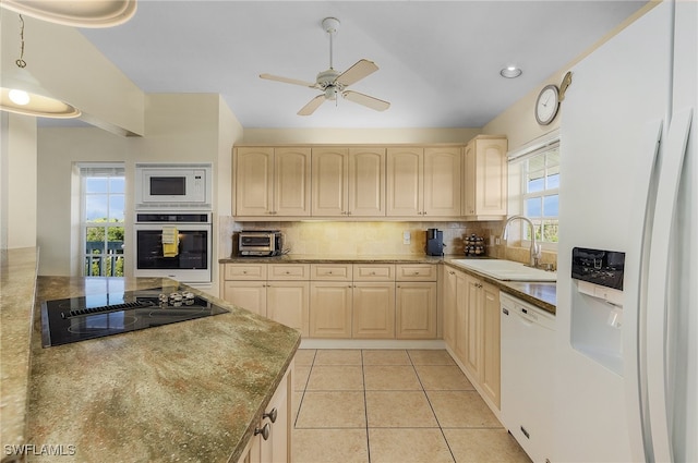 kitchen featuring sink, decorative backsplash, white appliances, light brown cabinets, and light tile patterned floors