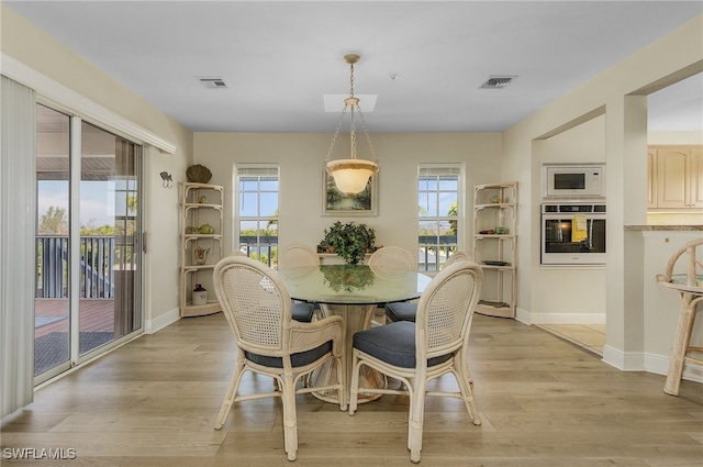 dining space featuring plenty of natural light and light hardwood / wood-style floors