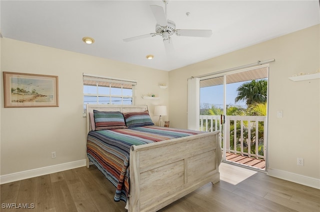 bedroom featuring light hardwood / wood-style flooring, multiple windows, and access to outside