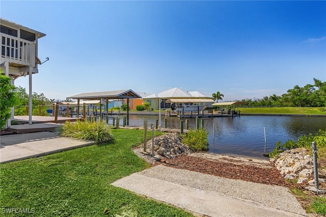 view of home's community featuring a water view, a boat dock, and a yard