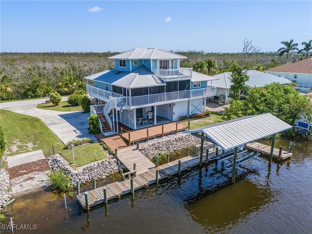 back of property with a deck with water view