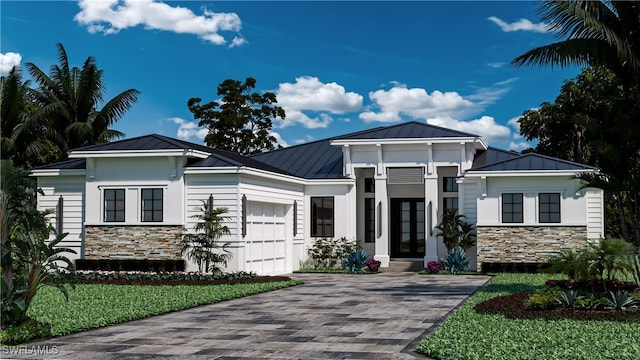 view of front of home with french doors and a garage