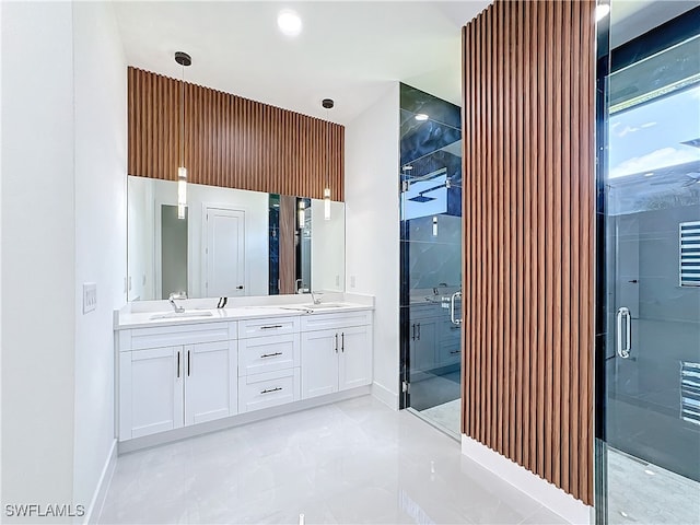 bathroom featuring tile patterned flooring, an enclosed shower, and vanity