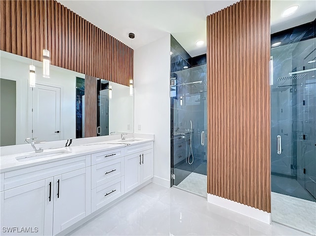 bathroom with tile patterned flooring, walk in shower, and vanity