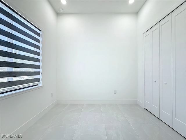 unfurnished bedroom featuring light tile patterned flooring