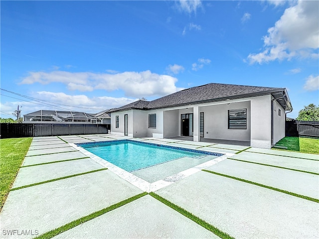 view of swimming pool featuring a lawn and a patio area