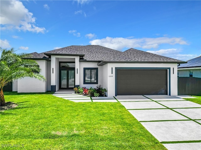 prairie-style home featuring a front lawn, solar panels, and a garage