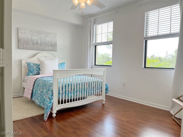 bedroom with dark wood-type flooring and ceiling fan