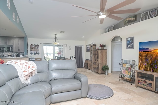 living room featuring lofted ceiling and ceiling fan