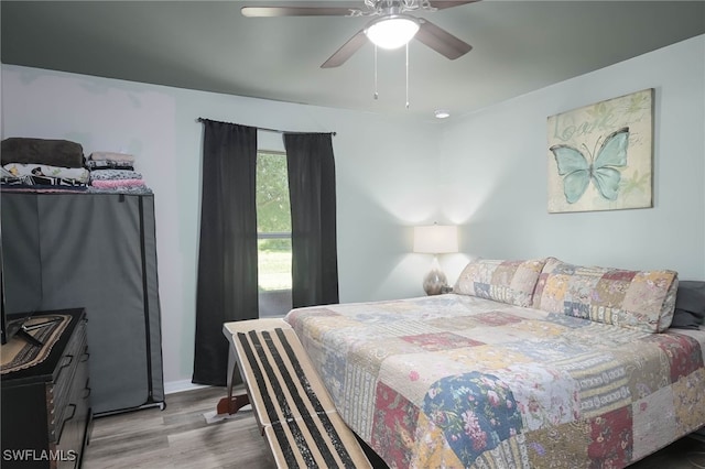 bedroom with ceiling fan and light hardwood / wood-style flooring