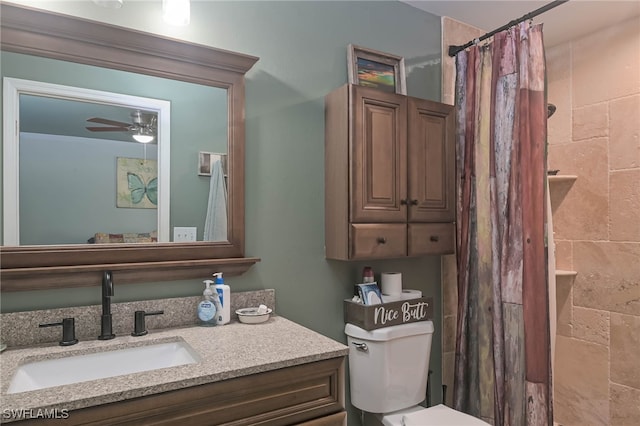 bathroom featuring ceiling fan, curtained shower, vanity, and toilet