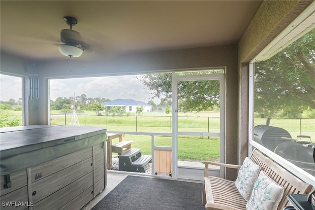 sunroom / solarium with ceiling fan and plenty of natural light