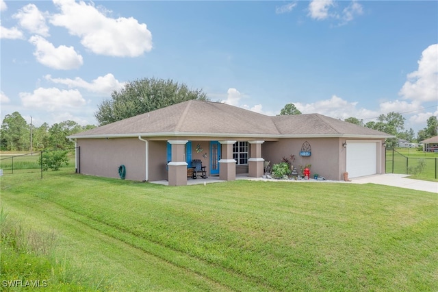 view of front of property with a front yard and a garage