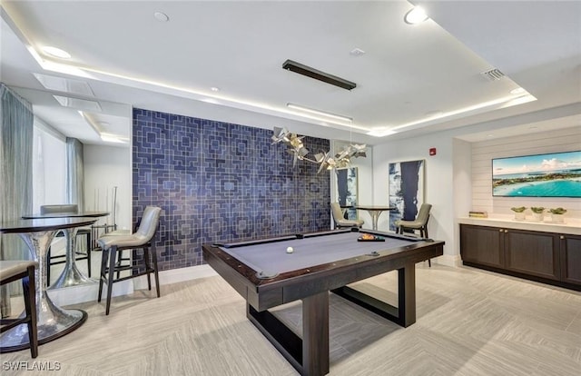 game room featuring light tile patterned flooring, tile walls, a tray ceiling, and pool table