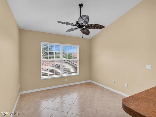 tiled empty room featuring ceiling fan