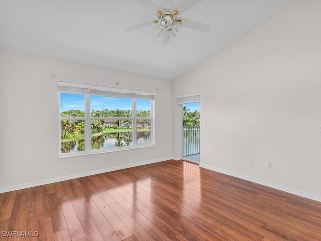 empty room with wood-type flooring, a water view, ceiling fan, and lofted ceiling