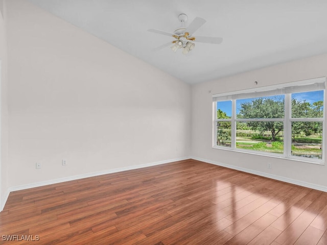 20141 Seagrove St Unit 308, Estero, FL 33928 - empty room with vaulted ceiling, wood finished floors, baseboards, and ceiling fan