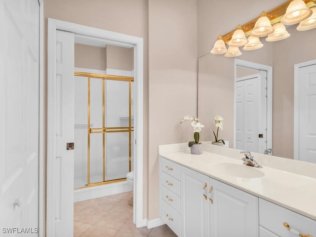 bathroom with tile patterned floors, vanity, toilet, and an enclosed shower