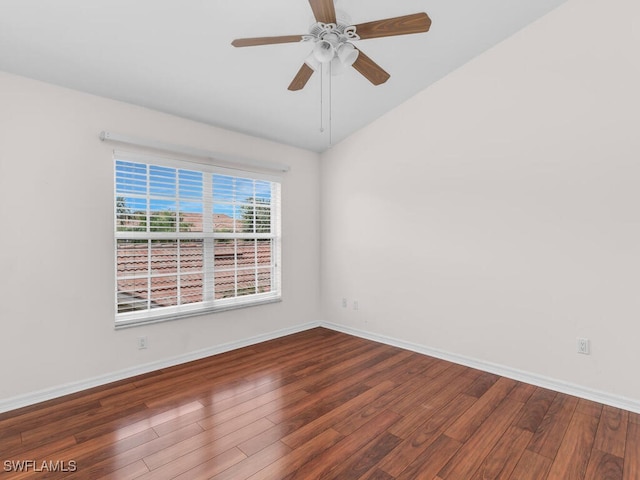 spare room featuring dark hardwood / wood-style flooring, vaulted ceiling, and ceiling fan