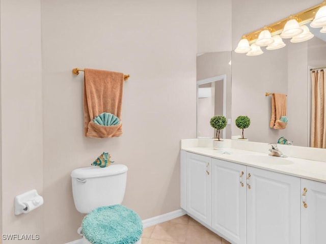 bathroom featuring tile patterned floors, vanity, and toilet